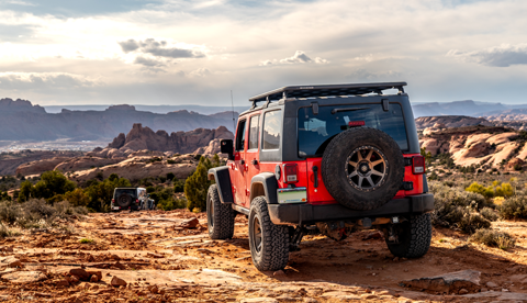 Jeeps driving down a rock trail in Moab Utah